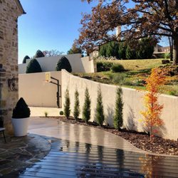 Tom's Outdoor Living - New landscape install! Coral Bark Maples and Taylor Junipers finishes shed off with decorative grasses.