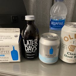 a variety of beverages on a counter a variety of beverages on a counter
