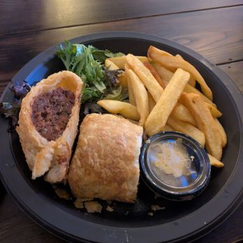 Leaky Cauldron™ - Sausage roll with spicy mustard and fries - British Near Me - Orlando, Florida