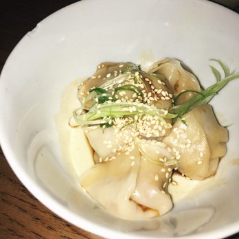 Baijiu - Pork & shrimp lion's head dumplings: pork, shrimp, garlic, soy, cabbage, and sesame basking in a ginger-soy sauce $11 - Cocktail Bars Near Me - Edmonton, Alberta