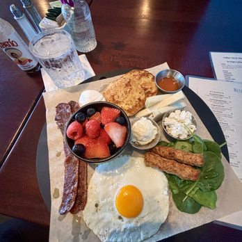 Let’s Yolk About It - Billionaire bacon, boiled egg, sunny side up egg, chefs choice cheese, spinach, sausage, English muffin, seasonal fruit - Breakfast & Brunch Near Me - Long Beach, California Let’s Yolk About It - Billionaire bacon, boiled egg, sunny side up egg, chefs choice cheese, spinach, sausage, English muffin, seasonal fruit - Breakfast & Brunch Near Me - Long Beach, California