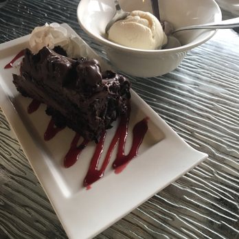 Longboards Tiki Beach Grille - Chocolate fudge cake with raspberry sauce, whipped cream and vanilla ice cream. - Seafood Near Me - Cocoa Beach, Florida