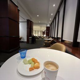 a plate of fruit and a cup of coffee a plate of fruit and a cup of coffee