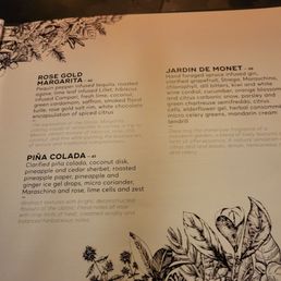 Menu - A menu page with detailed descriptions of cocktails and infusions, decorated with black botanical illustrations at the bottom and left side.