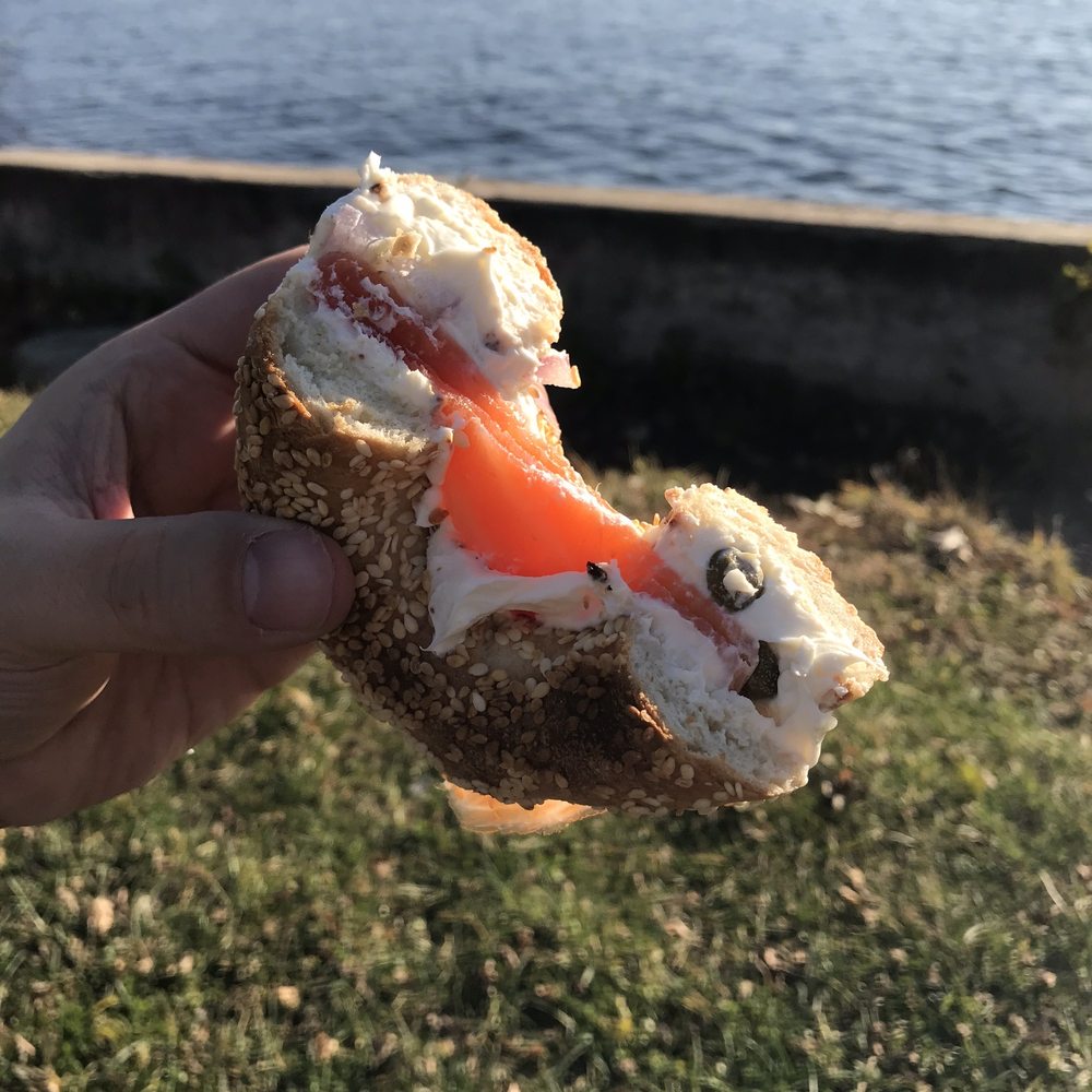 M.T.L. Bagel - a hand holding a bagel with cream cheese and salmon - Bagels Near Me - Côte Saint-Luc, Quebec M.T.L. Bagel - a hand holding a bagel with cream cheese and salmon - Bagels Near Me - Côte Saint-Luc, Quebec
