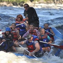 Magic Falls Rafting - Magic's owner, Dave guides a family through the waves.