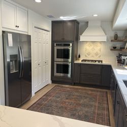 Western States Cabinets - View of the white cabinet over the refrigerator and cabinets above and below the double oven