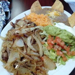Bistec encebollado - Steak, onions, beans, rice, guac and comes with a side of warm corn tortillas