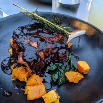 Black Rail Kitchen + Bar - HOUSE-BRINED BONE-IN DUROC PORK CHOP ratatouille, adobo butter - Mediterranean Near Me - Carlsbad, California Black Rail Kitchen + Bar - HOUSE-BRINED BONE-IN DUROC PORK CHOP ratatouille, adobo butter - Mediterranean Near Me - Carlsbad, California