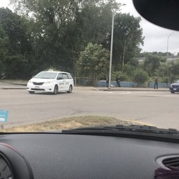 MetroCab by Quincy BJs blocking two lanes of traffic with the green light trying to make a left turn from the right-hand lane.