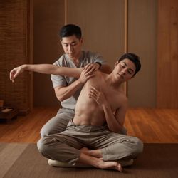 Thai massage combining deep pressure and assisted stretching.