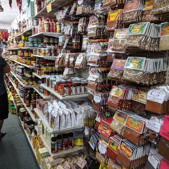 Chile Addict - a woman shopping in a grocery store - Herbs & Spices Near Me - Albuquerque, New Mexico