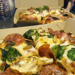 Personal pan pizza with pepperoni, mushrooms, spinach, and garlic butter crust