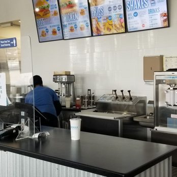 Boardwalk - a restaurant counter with menus on the wall - Halal Near Me - Scarborough, Ontario