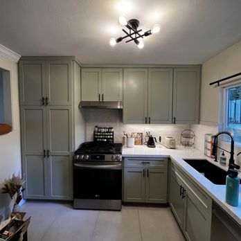 Tgibbs Construction - a kitchen with a sink, stove, and refrigerator - General Contractors Near Me