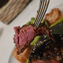 The Regency Room - A juicy piece of medium rare Filet on a fork.