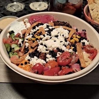 CAVA - preserved lemon, tahini, Caesar with tomato cucumber, corn, chicken, meatballs, pita strips, arugula, rice, feta, Tzatziki, hummus, lentils - Mediterranean Near Me - Atlanta, Georgia CAVA - preserved lemon, tahini, Caesar with tomato cucumber, corn, chicken, meatballs, pita strips, arugula, rice, feta, Tzatziki, hummus, lentils - Mediterranean Near Me - Atlanta, Georgia