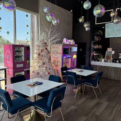 BOBO CHA BAR Interior with seating area, vending machines and cotton candy machine.