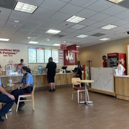 a man sitting at a table in a fast food restaurant
