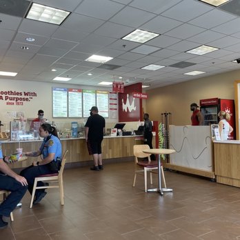 Smoothie King - a man sitting at a table in a fast food restaurant - Health Markets Near Me - Davie, Florida