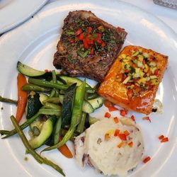 Main meal with salmon, steak, mashed potatoes, veggies