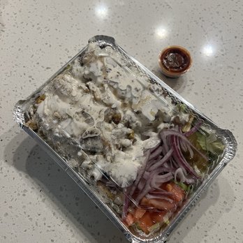 Halal taza - a container of food on a table - Mediterranean Near Me - Austin, Texas