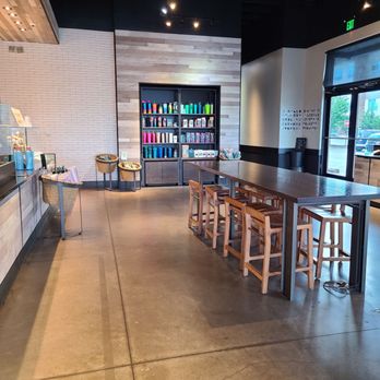 Starbucks - The entrance door with middle high table and stools. - Coffee & Tea Near Me - Roanoke, Virginia