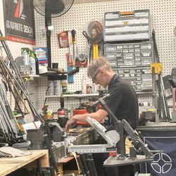 Roger Dunn Golf Shops - Scott putting glue on the club heads