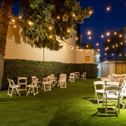 Atlantis Hall - Atlantis Hall Backyard night time cocktail setup with string lights
