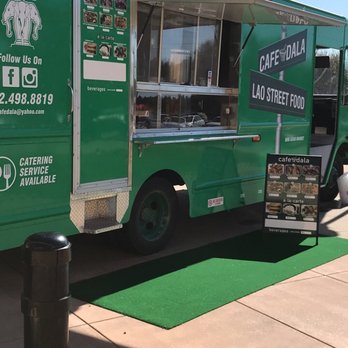 Cafe dala - a green food truck parked on a sidewalk - Food Trucks Near Me