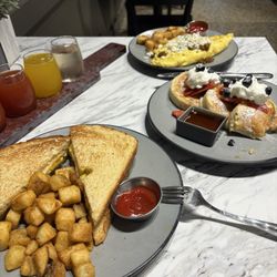 Jackson’s Kitchen & Catering - Mimosa flight, chorizo omelet, pancakes and smash sandwich