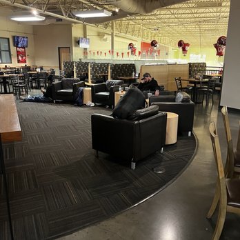 Hy-Vee - a man sitting on a couch in a restaurant - Grocery Near Me - Overland Park, Kansas