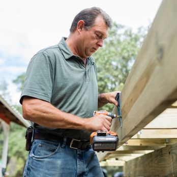 S&V Property Solutions - a man using a nail gun to nail down a piece of wood - Decks & Railing Near Me S&V Property Solutions - a man using a nail gun to nail down a piece of wood - Decks & Railing Near Me