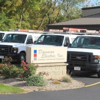 Dauman Electric - a line of trucks parked in a parking lot - Electricians Near Me - Fall River, Wisconsin
