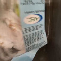 a bag of frozen chicken in a refrigerator