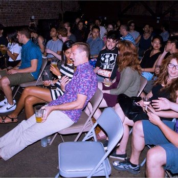 Comedians You Should Know NYC - a crowd of people sitting in chairs - Comedy Clubs Near Me - Brooklyn, New York Comedians You Should Know NYC - a crowd of people sitting in chairs - Comedy Clubs Near Me - Brooklyn, New York