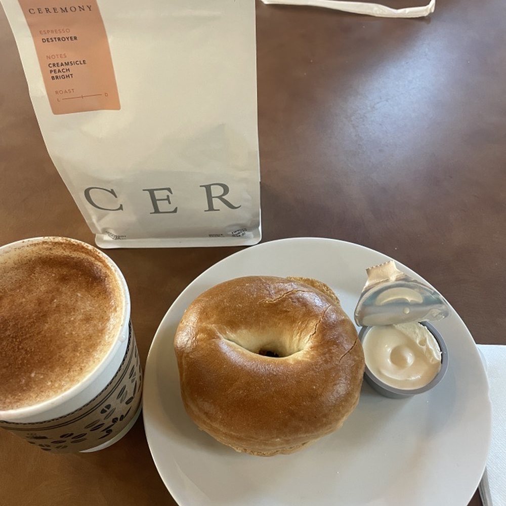 Concord Point Coffee - Latte with some cinnamon. Plain Bagel Featuring the coffee bean used for the latte. - Cafes Near Me - Havre de Grace, Maryland Concord Point Coffee - Latte with some cinnamon. Plain Bagel Featuring the coffee bean used for the latte. - Cafes Near Me - Havre de Grace, Maryland