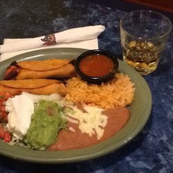 Taquitos Mexicanos with rice beans, guacamole, sour cream and pico de gallo