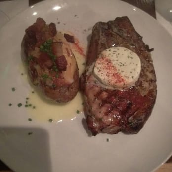 Saltus River Grill - Pork chop with truffle butter and a twice baked potatoe. - Sushi Bars Near Me - Beaufort, South Carolina Saltus River Grill - Pork chop with truffle butter and a twice baked potatoe. - Sushi Bars Near Me - Beaufort, South Carolina