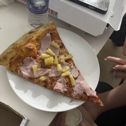 Raw uncooked pizza with cold ham and pineapple