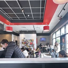 [INTERIOR] Fast food style seating. Largest table seats 6 or 8. Line runs along the wall & order at counter.