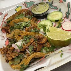 Villa's Patio Mexican Restaurant - Al pastor tacos with green salsa, radishes, cucumbers, and lime slices.
