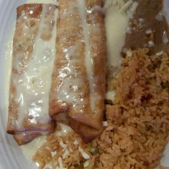 Uncle Paco’s Mexican Grill - Chimi Con Queso 2 chimichangas covered with queso w/ rice & beans - Mexican Near Me - Tulsa, Oklahoma Uncle Paco’s Mexican Grill - Chimi Con Queso 2 chimichangas covered with queso w/ rice & beans - Mexican Near Me - Tulsa, Oklahoma