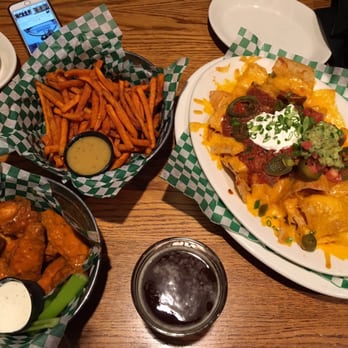 Jake Melnick's Corner Tap - Nachos, sweet potatoe chips and chicken wings. Chicken wings is very hot - Sports Bars Near Me - Chicago, Illinois Jake Melnick's Corner Tap - Nachos, sweet potatoe chips and chicken wings. Chicken wings is very hot - Sports Bars Near Me - Chicago, Illinois