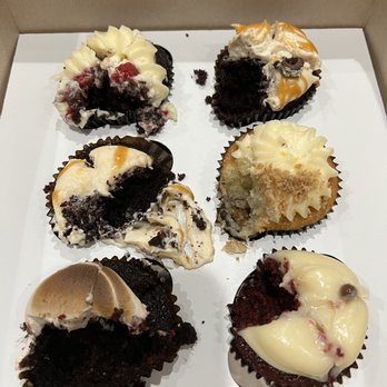 Cupcakin' Bake Shop - Woops dug in b4 pic. From back top left to right: Raspberry, Mocha, sea salt, lemon, s'mores, red velvet - Cupcakes Near Me - Oakland, California Cupcakin' Bake Shop - Woops dug in b4 pic. From back top left to right: Raspberry, Mocha, sea salt, lemon, s'mores, red velvet - Cupcakes Near Me - Oakland, California