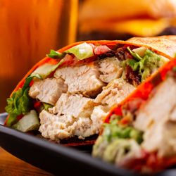 Tap Room - Grilled chicken, fresh avocado, crispy bacon, Swiss cheese, lettuce, tomato, ranch dressing. served in a tomato basil wrap.