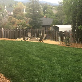 Living Water Landscape & Design - a backyard with a fire pit - Landscaping Near Me