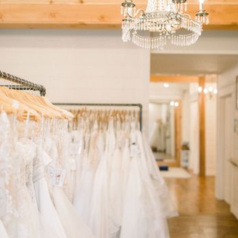 Cleo Bridal - Wedding dresses hanging in room with chandelier. - Bridal Near Me - O'Fallon, Missouri Cleo Bridal - Wedding dresses hanging in room with chandelier. - Bridal Near Me - O'Fallon, Missouri