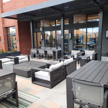 Residence Inn by Marriott Atlanta Covington - Large outdoor seating area with tables, sofas, upholstered chairs - Hotels Near Me - Covington, Georgia