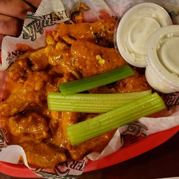 Jeremiah's Tavern - a basket of buffalo wings and celery - New American Near Me - Rochester, New York